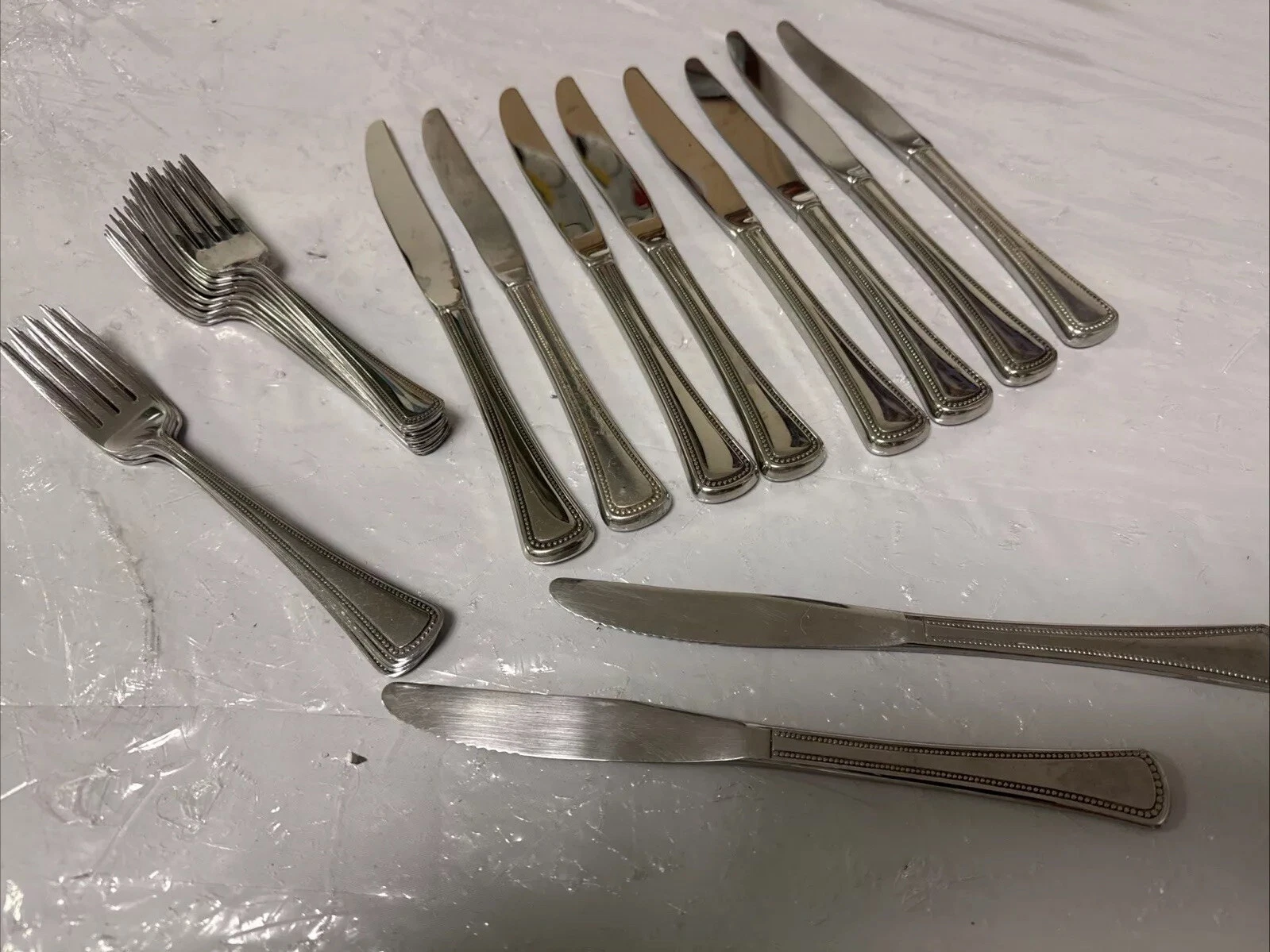 8 Butter Knives 2 Thinner Serrated Knives 4 Forks & 9 Smaller Forks Same Pattern