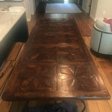 dining table: custom parquet wood surface and decorative wrought iron base
