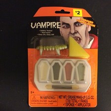 Vampire Teeth and Cosmetic Grease Makeup for Halloween Costume
