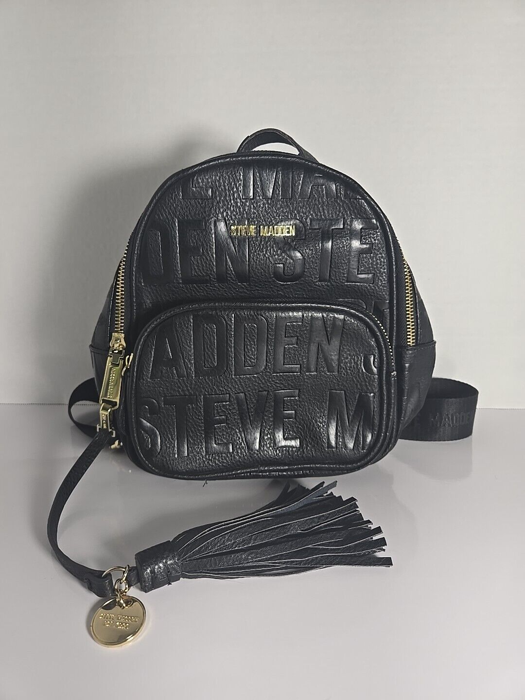 Steve Madden Mini Backpack Black Gold Logo Zippers Tassel Charm