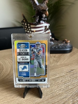 2023 Panini Contenders Optic - Season Ticket Amon-Ra St. Brown #16 Gold Prizm.