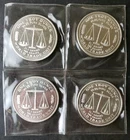 Four 1986 1oz Silver World Trade Unit Rounds in Plastic