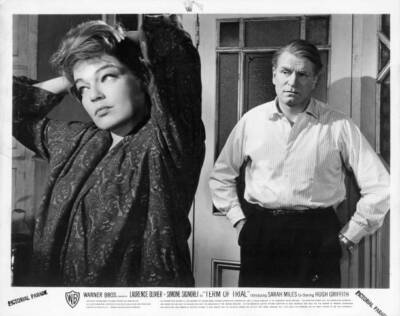 Simone Signoret styles her hair as Laurence Olivier watches in Ter- Old Photo