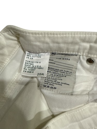 White AG Adriano Goldschmied jeans, 25R, with black tag showing size, composition, and care instructions.