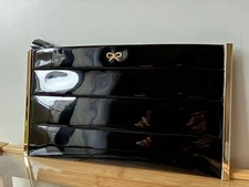 Anya Hindmarch clutch bag in patent enamel and black