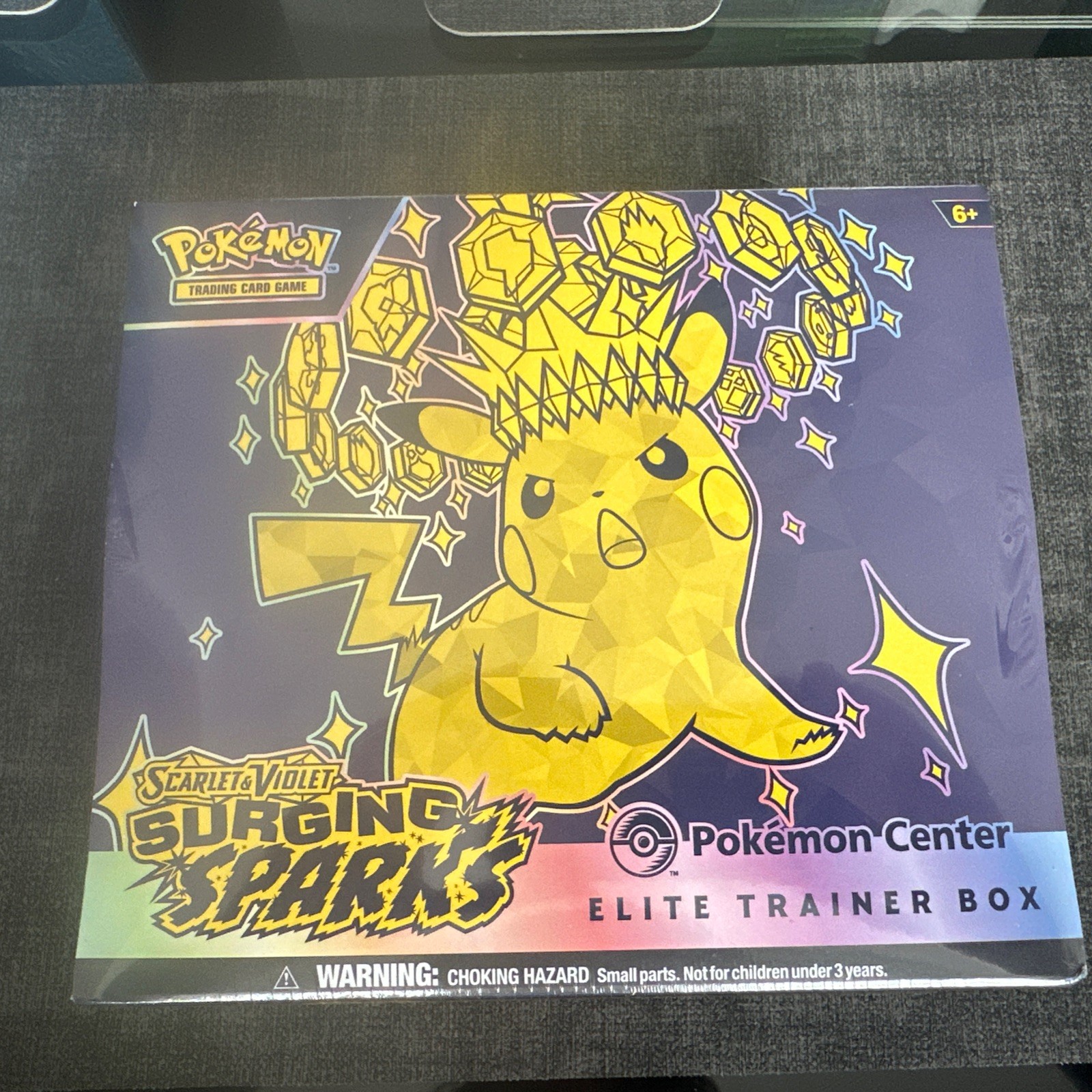 Surging Sparks Pokemon Center ETB - New and Sealed - small tear in plastic 