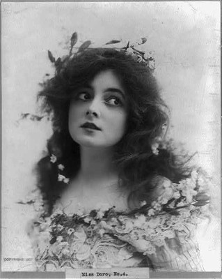 Miss Doro,attractive young woman decorated with flowers,c1902,woman portrait