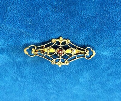 Vintage pretty Gold Tone Horizontal Filigree pin with red stone in a center