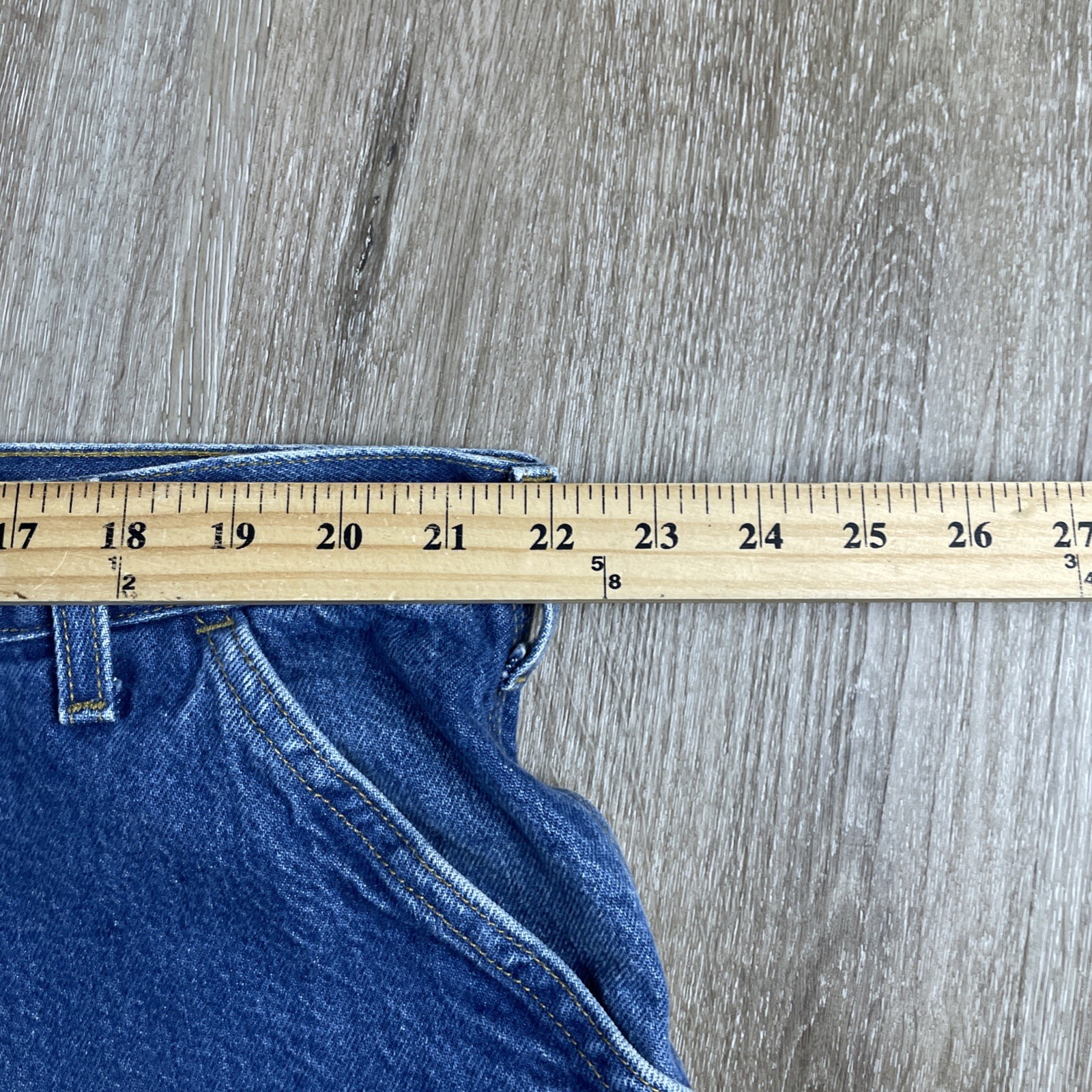 Blue denim Y2K Carhartt men’s carpenter jeans with faded thighs, measured at 44x30 USA made workwear.