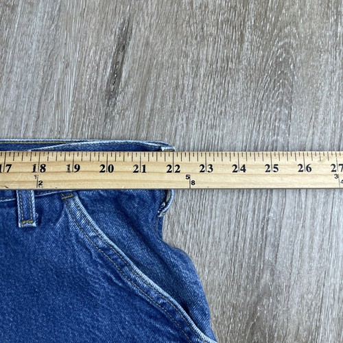 Blue denim Y2K Carhartt men’s carpenter jeans with faded thighs, measured at 44x30 USA made workwear.
