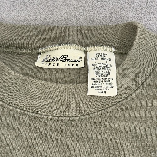 Gray vintage Eddie Bauer sweatshirt size L with white printed inner label showing care and bleach text.