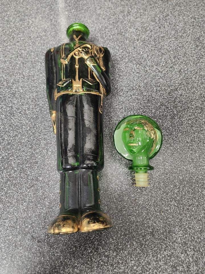 A hand-blown green glass Italian wine decanter shaped like a soldier — the kind of conversation-starting barware you stumble upon once and never forget.