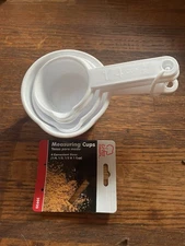 Set of Four Measuring Cups. White Plastic. New.