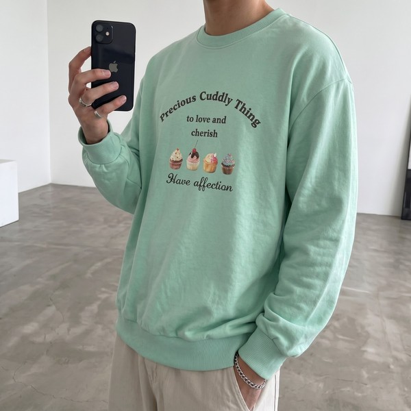 Mint green crewneck sweatshirt with quirky cupcake graphic