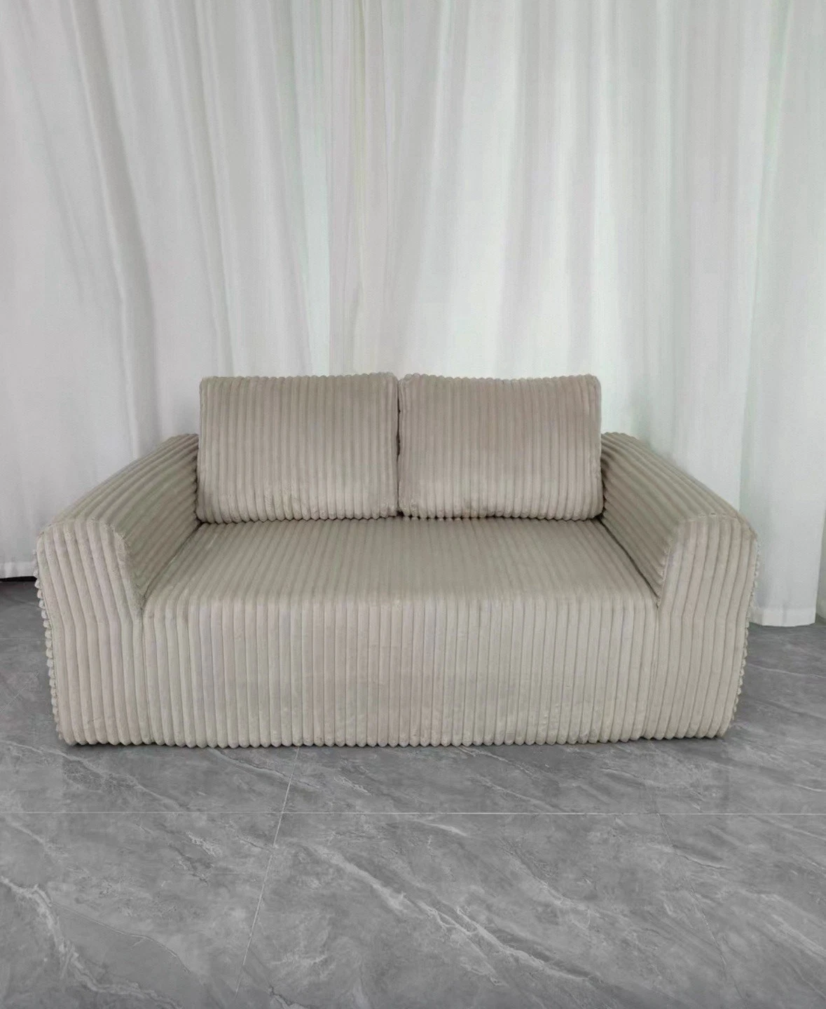 Cream-colored compressed fabric sofa