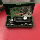 Green carry-over Singer Box with red and white label showing front panel of Buttonholer 160506 and visible screw size S.