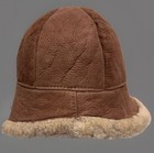 Brown suede vintage ranchero bucket hat with creased crown, tan sheepskin lining, and dark brown stitching.