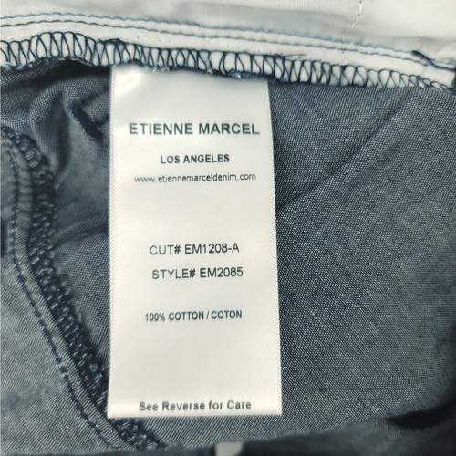 White fabric tag on waistband of blue skinny crop jeans with “ETIENNE MARCEL LOS ANGELES” text and product details.