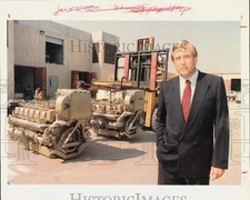 1988 Press Photo Ray Carroll stands near diesel engines at MTU of North America.