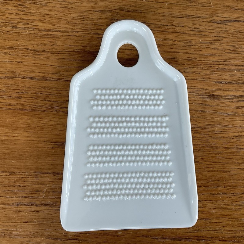 White porcelain or ceramic hand grater~ginger~garlic~parmesan~citrus~wasabi