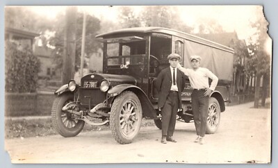 RPPC 2 Men next to truck c.1920s- Minn. plate- ID back as Johnson Candy co