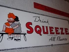 VINTAGE "DRINK ORANGE SQUEEZE BOY GIRL KISSING 18" PORCELAIN METAL SODA GAS SIGN