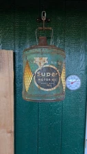 repurposed vintage Conoco Super Motor Oil can transformed into a hanging lantern