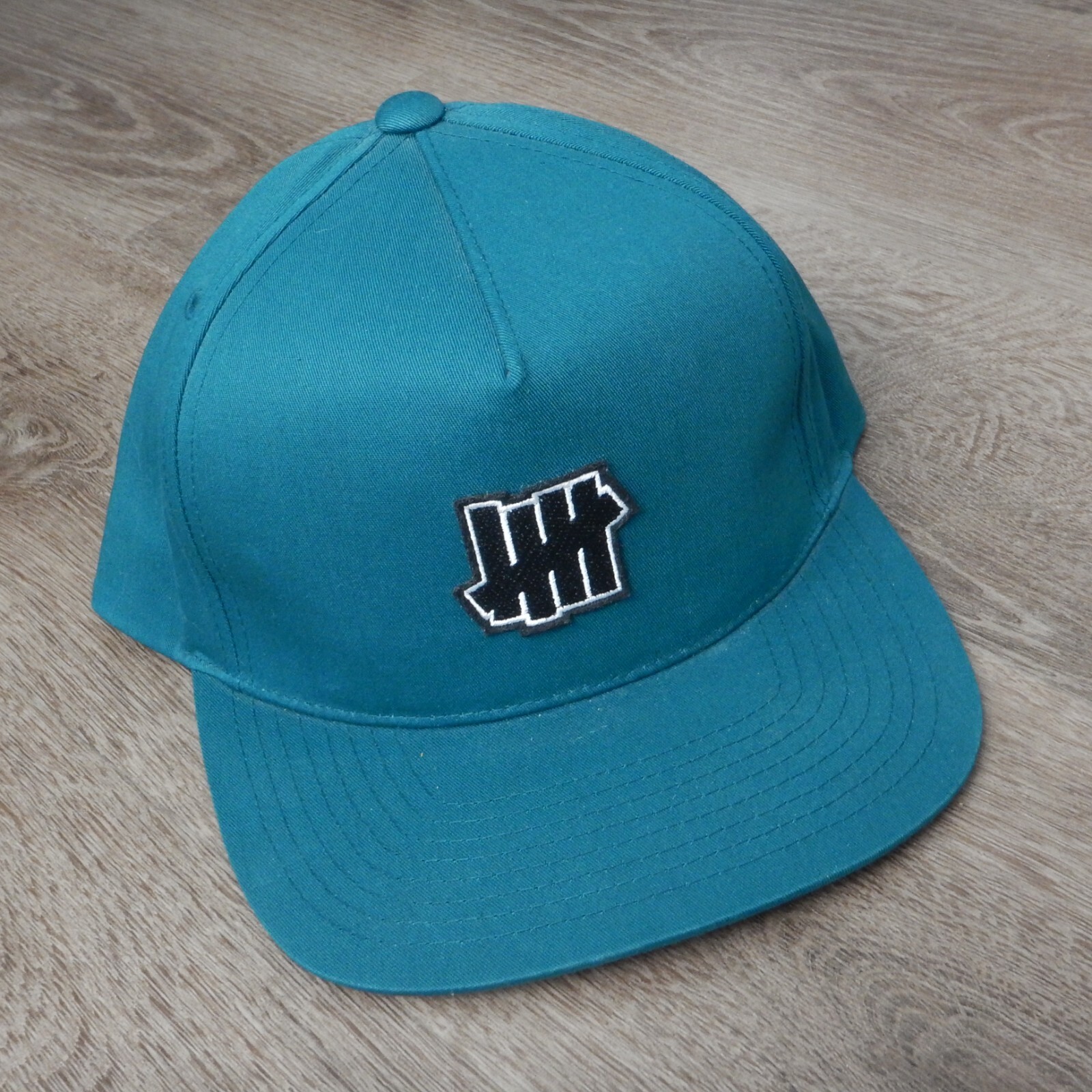 SAMPLE Undefeated Turquoise Five Strikes Logo Sna… - image 1
