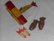 Pre war tin airplane dropping bombs bundled