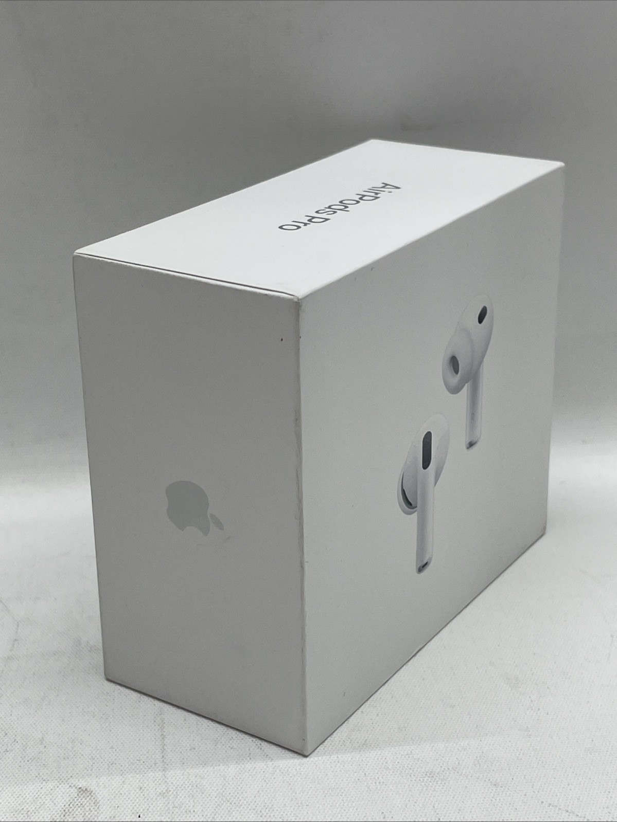 White Apple AirPods Pro 3 box with silver earbuds shown, featuring black Apple logo on lid and side.