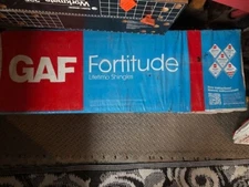 Six unopened GAF Fortitude Lifetime Shingles in Amber Brown