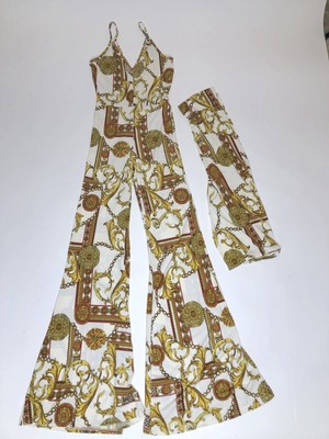 white jumpsuit with gold belt