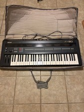 1980 s Akai synthesizer with case and stand.