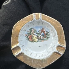 LIDO WS George Canarytone 22K Gold Crest-O-Gold Ash Tray Man With Flute And Lady