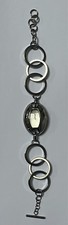 Mango ladies analogue watch with oval face and flexible metal linked strap
