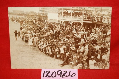 Many school children on a beach, no title given Ocea...