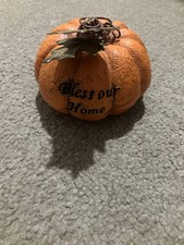 a fall-themed, tabletop pumpkin decoration with a metal leaf