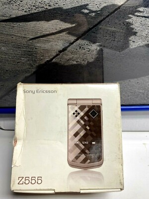 Old Sony Ericsson Mobile Phone With Its Charger On A Dark Background Vintage Vodafone Logo Lying Surface Image386711914