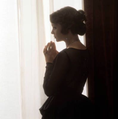 Italian Actress Laura Antonelli Looking Through A Curtain In The Film PHOTO