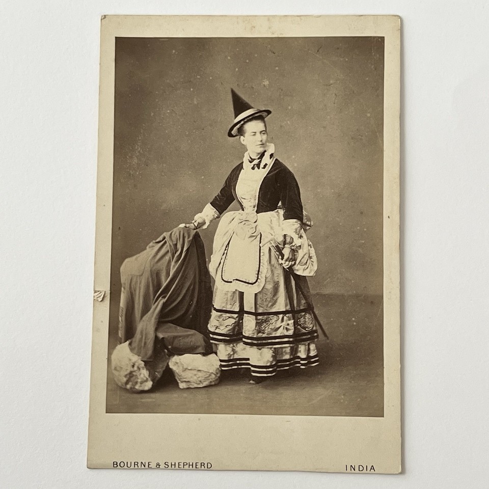A genuine antique cabinet card photo of a woman in a witch costume — haunting, bizarre, and utterly one-of-a-kind Victorian-era artifact from India.