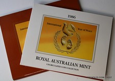 * 1986   7 COIN MINT SET YEAR OF PEACE DESIGN DOLLAR  IN FOLDER LOT NCLT #DVR35