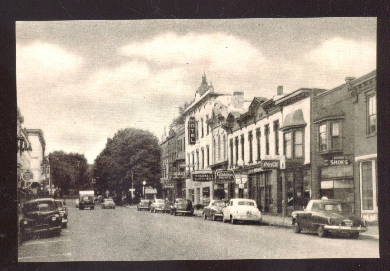 REAL PHOTO MILLERSBURG OHIO DOWNTOWN STREET SCENE OLD CARS POSTCARD