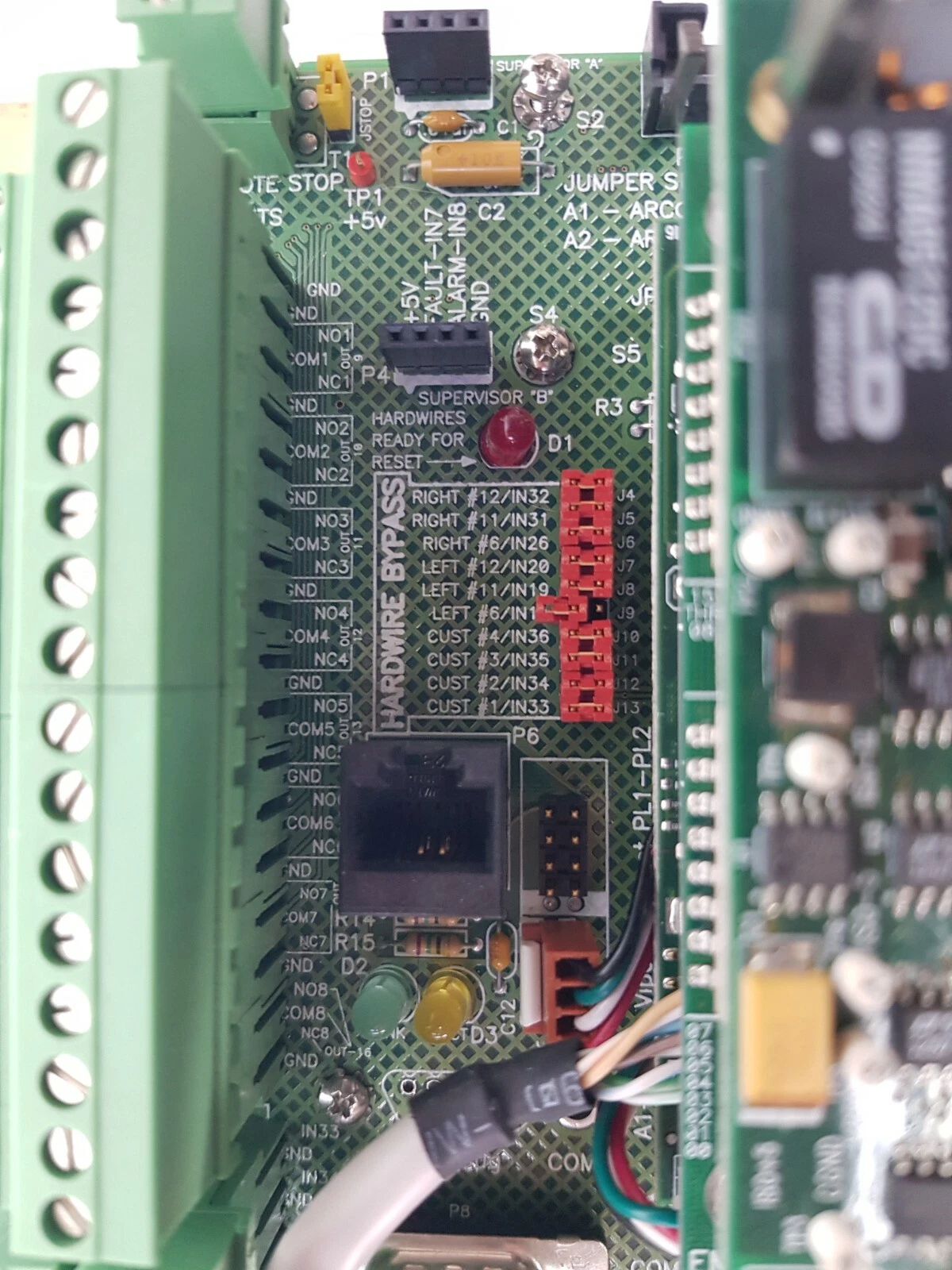 Screw terminal blocks and hardwire bypass jumpers on the Gasguard AP10 System I/O board