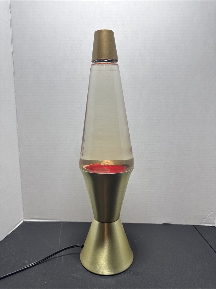 An original 1988 Lava Lite with a gold base and red liquid — old enough to be a genuine collector's piece but still iconic enough to display on any shelf.