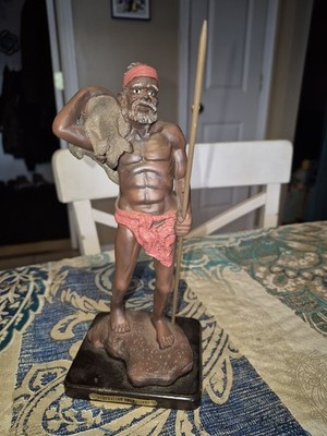 Australian Aboriginal figurine (23.5 cm tall). Resin with wooden base.