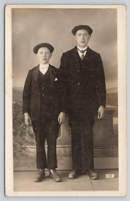 Postcard RPPC Two Brothers Boys Flat Caps Working Class Studio Portrait Siblings