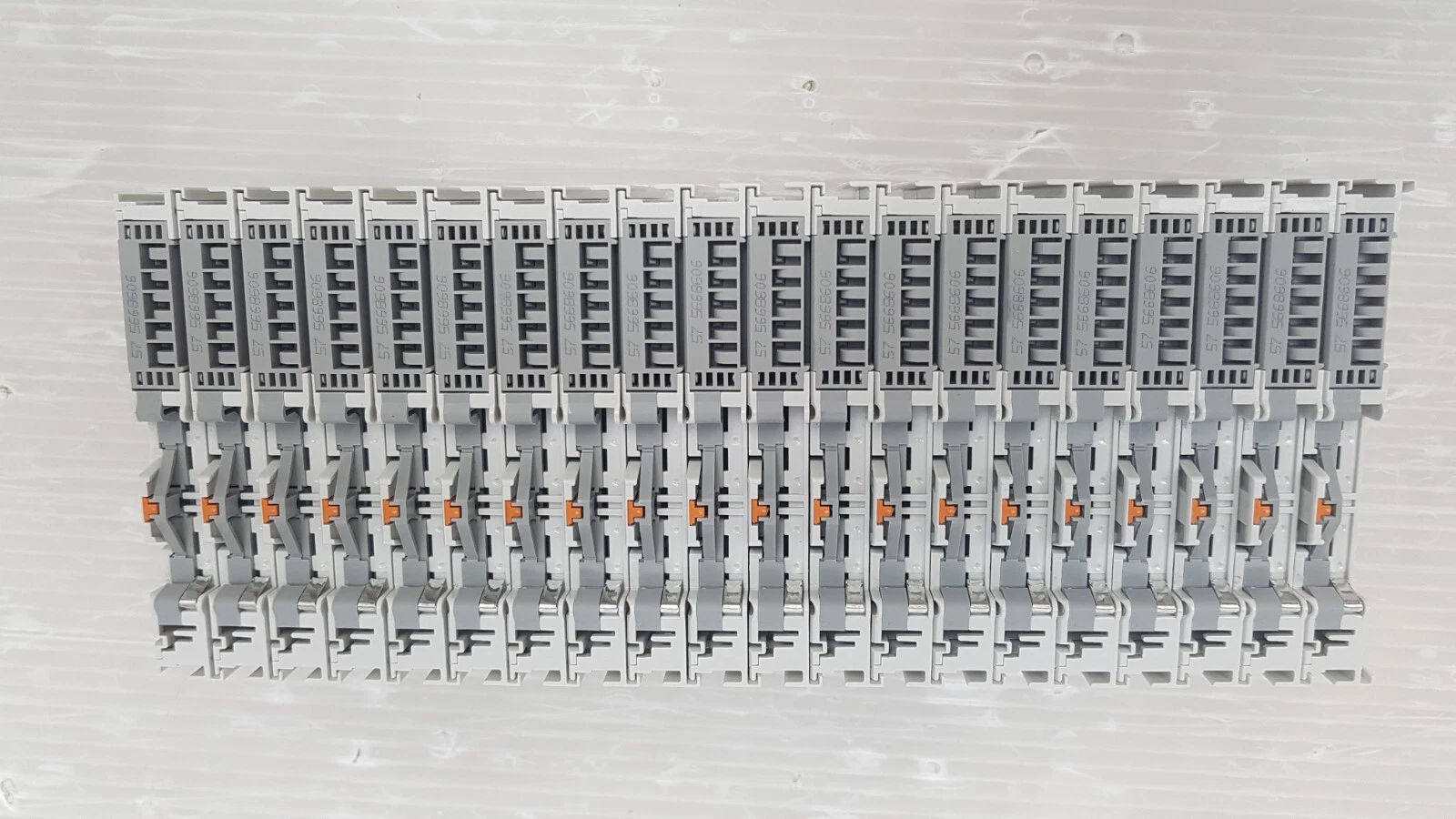 Back of 20 Beckhoff KL9185 terminals showing the DIN rail clips