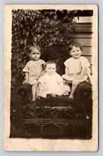 RPPC 3 children outside chair Postcard Portrait Real Photo Vtg azo babies
