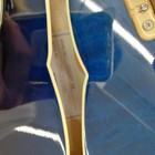 Blue hollow body electric guitar with white label, gold hardware, and serial number etched in the side.