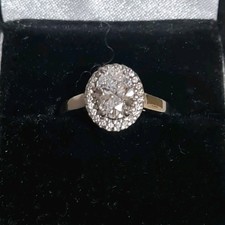 total 1.5ct, centre Oval 1.25ct Lab created Diamond. Halo natural. 18ct gold